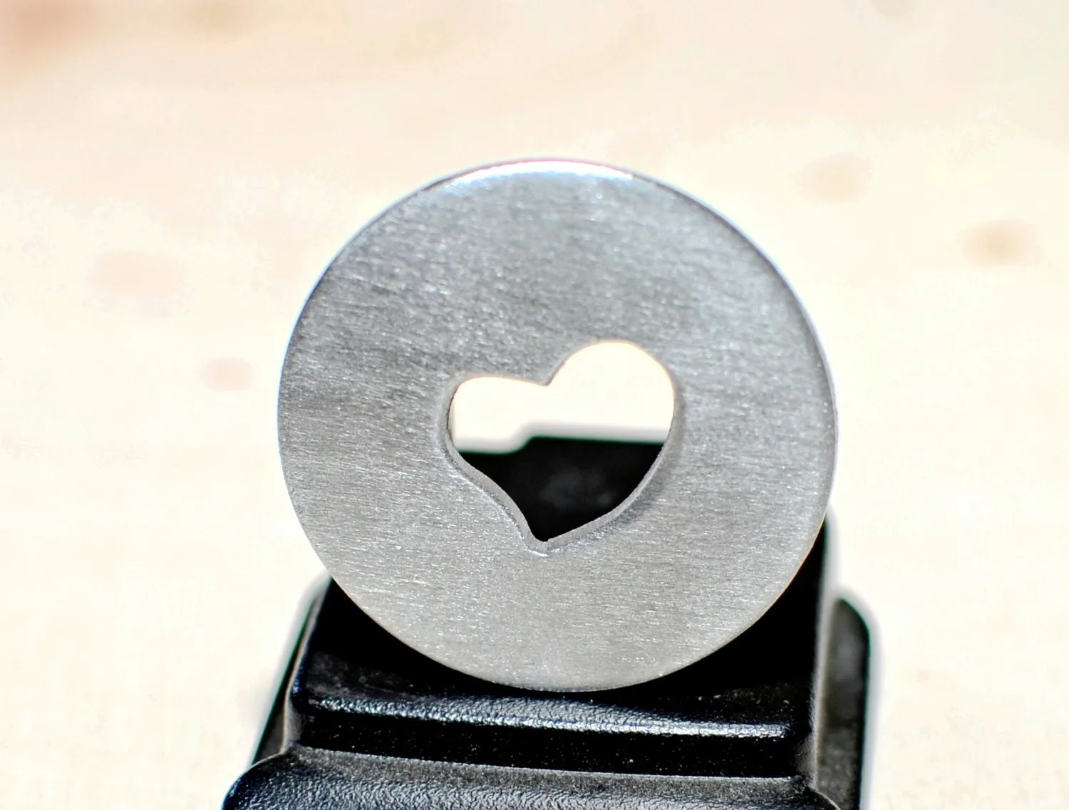 Golf ball marker with a heart cut out
