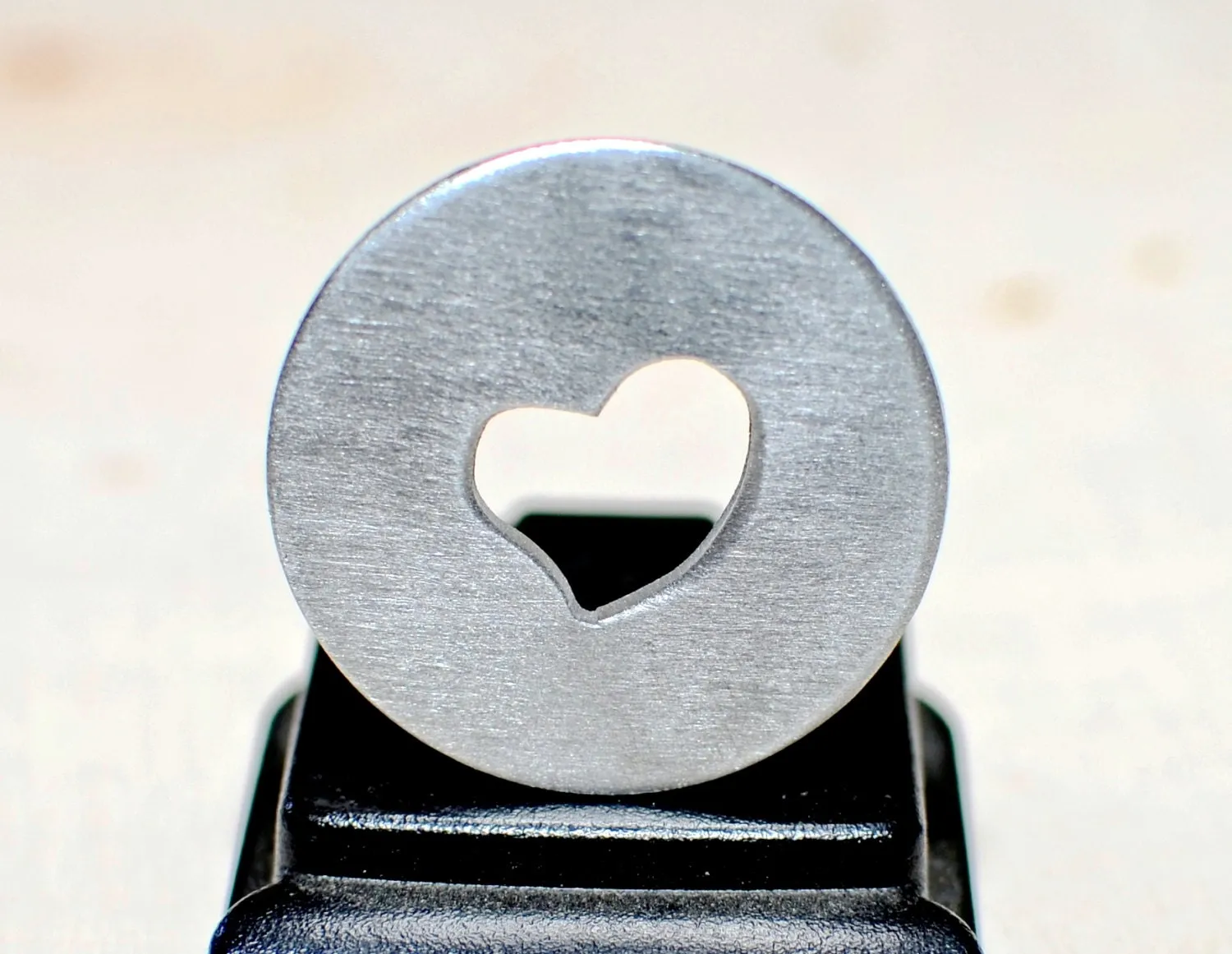 Golf ball marker with a heart cut out